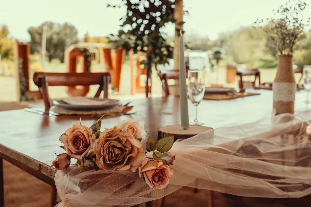 Reception table styling with roses and LOVE letters in the grounds at Woodhill Weddings dry hire wedding venue, Faversham, Kent