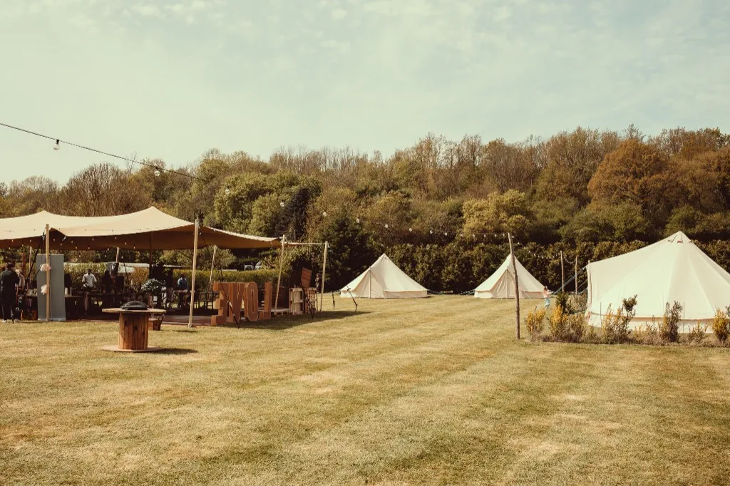 Stretch tent, bell tents and giant LOVE letters across the grounds at Woodhill Weddings, Faversham, Kent
