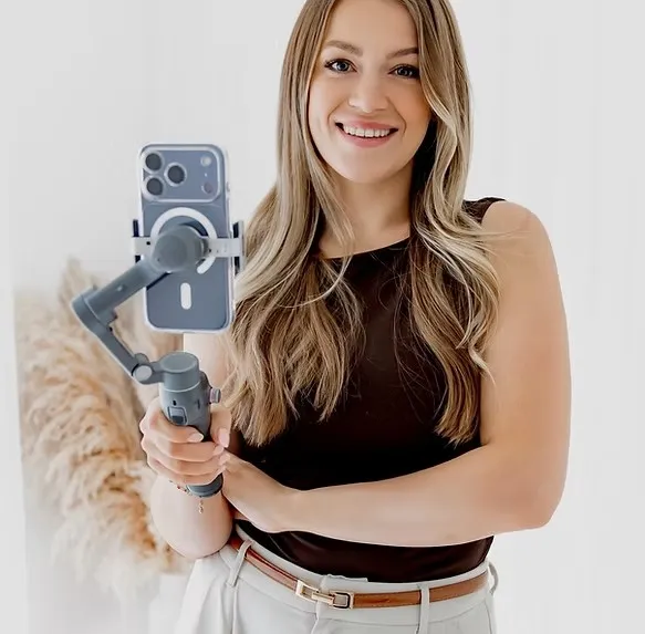 Indie of IndieTheContentGuest holding a smartphone on a gimbal for wedding content creation